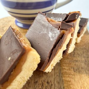 Millionaire shortbread tray bake with a cup of tea