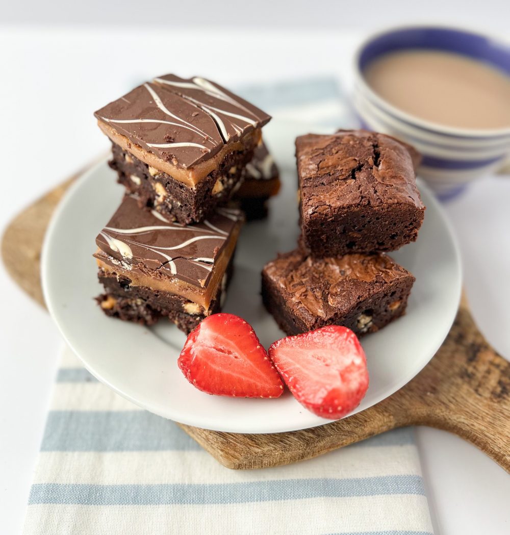 chocolate brownie and billionaire brownie squares on a plate