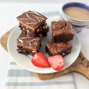 chocolate brownie and billionaire brownie squares on a plate